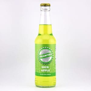 A clear glass bottle of Shawnee Sour Apple soda pop, filled with bright green liquid, is centered against a plain white background.
